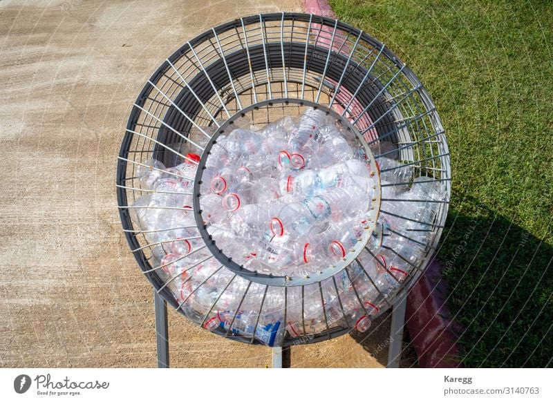 plastic bottles are collected in a metal basket schön Kind Mensch Klima Verpackung Kunststoffverpackung Sack Container Glas Zeichen trashig Recycling cheerful