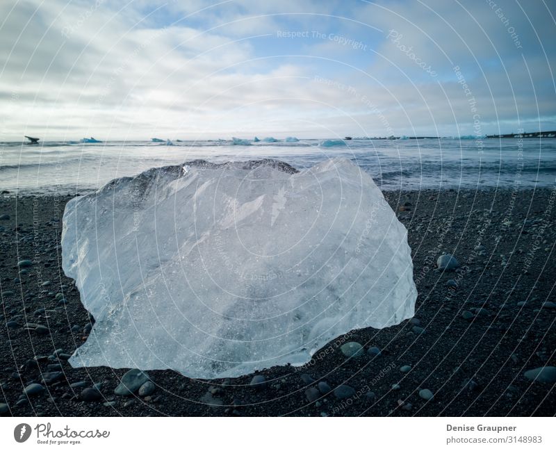 Ice chunks on the black beach of Iceland Ferien & Urlaub & Reisen Sommer Strand Natur Sand Himmel Blick Schnellzug Island jokulsarlon landscape natural water