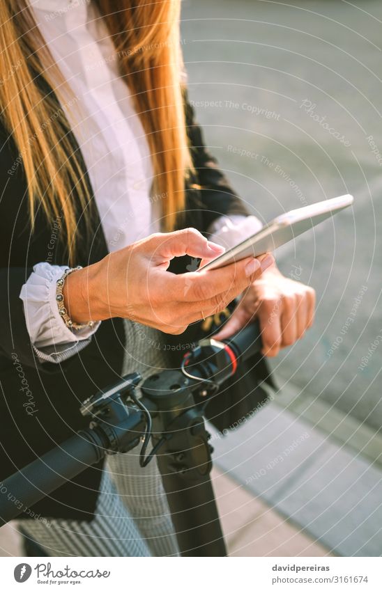 Detail des Mobiles der Geschäftsfrau mit Elektroroller elegant Stil PDA Mensch Frau Erwachsene Hand Verkehr Straße Mode modern E-Roller Fahrradlenker urban