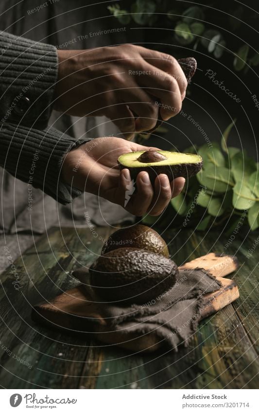 Person, die Avocados an den Händen hält geschnitten Diät exotisch Lebensmittel frisch Frucht grün Hälfte Gesundheit natürlich Natur Ernährung organisch roh reif