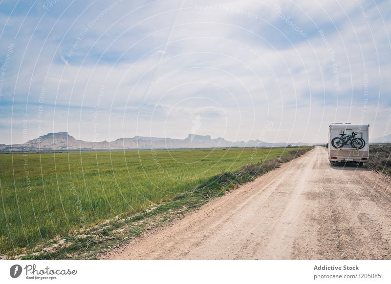 Weißer Anhänger auf leerer Straße zwischen Feldern mit Vegetation erstaunlich ausleeren Ferien & Urlaub & Reisen Karavane Landschaft Natur Asphalt Ausflug halb