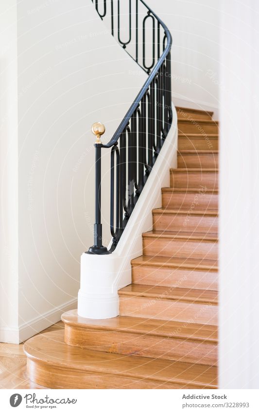 Klassische Holztreppe mit breiten Holzstufen Treppenhaus klassisch hölzern Design Villa Herrenhaus Anwesen Schritt Geländer Reling Haus Innenbereich Licht