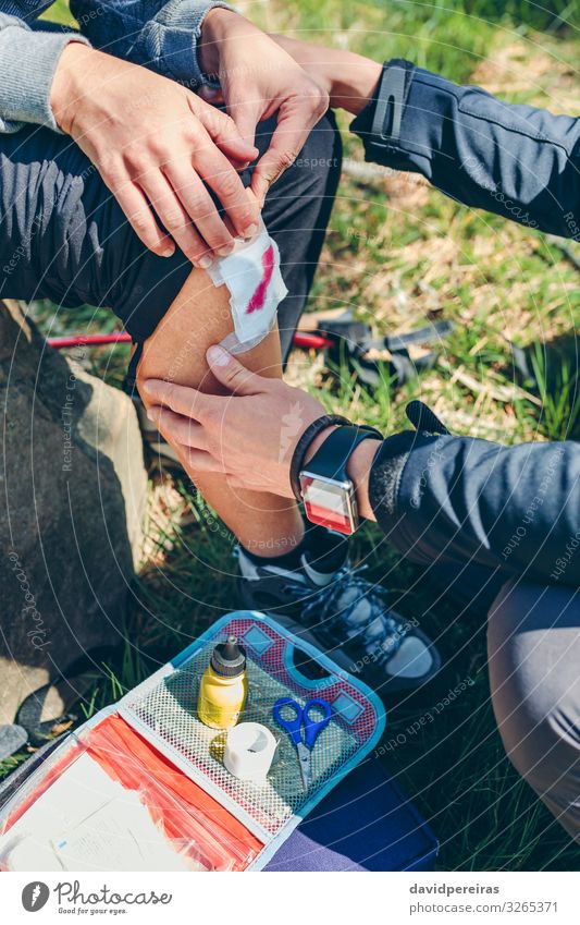 Mann heilt beim Trekking verletztes Knie einer Frau Lifestyle Berge u. Gebirge wandern Schere Mensch Erwachsene Paar Natur Herbst Wald sitzen authentisch Wunde