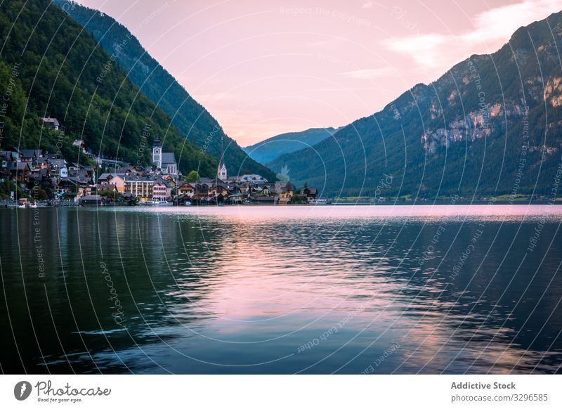 Ruhiger See und Stadt in der Nähe der Berge Berge u. Gebirge Windstille Ufer wolkig tagsüber Landschaft Wasser Österreich malerisch Haus Architektur Außenseite