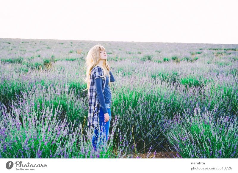 Junge blonde Frau allein in einem Lavendelfeld jung Natur Leben Garten Gartenarbeit Parfüm Frühling Blumen Feld lieblich Freiheit offen wirklich echte Frau