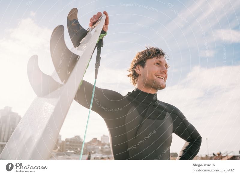 Surfer, der mit einem Surfbrett am Strand steht. Lifestyle Glück Erholung Freizeit & Hobby Abenteuer Meer Wellen Sport Mensch maskulin Mann Erwachsene 1