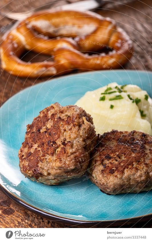 Fleischpflanzerl auf einem Teller Abendessen Gastronomie Wärme Holz lecker saftig blau braun Pflanzerl Fleischklösse fleischpflanzerl Kartoffelpüree Hackfleisch