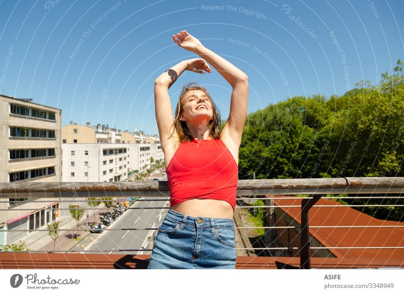 Junge schöne Frau beim Sonnenbaden auf einer Brücke über die Stadt Lifestyle Freude Glück Erholung Freizeit & Hobby Sommer Erwachsene Jugendliche Arme Natur