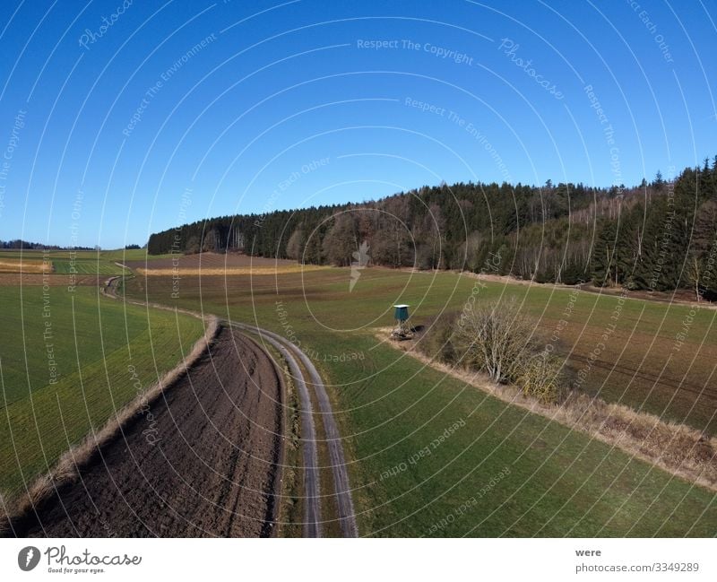 Aerial view of a dirt road between fields Umwelt Natur Feld groß Unendlichkeit Stadt Area flight aerial view bird's eye view copter country countryside