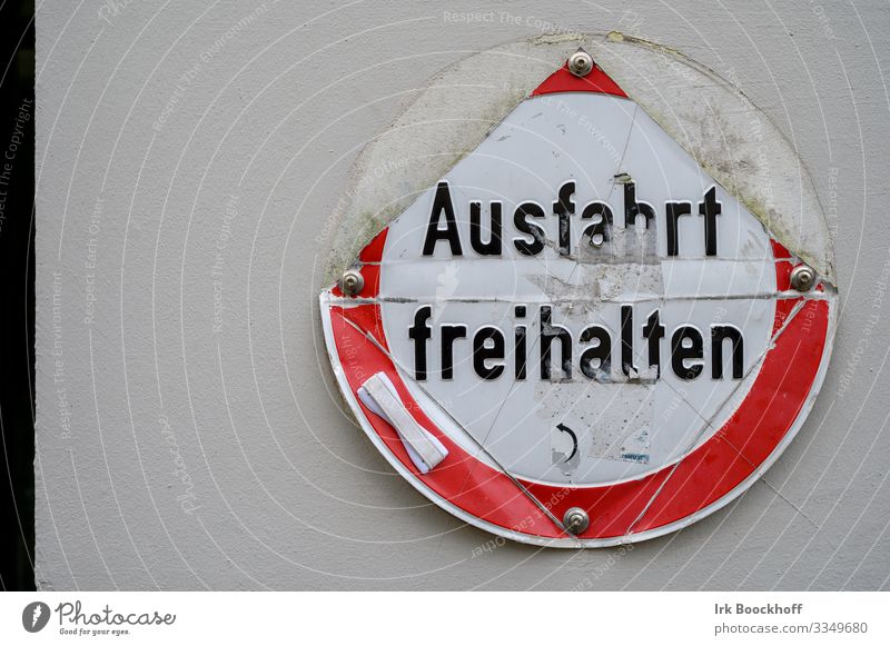 zerstörtes Ausfahrt freihalten Schild vor weißer Wand Stadt Stadtzentrum Menschenleer Haus Mauer Verkehr Straßenverkehr Verkehrszeichen Verkehrsschild