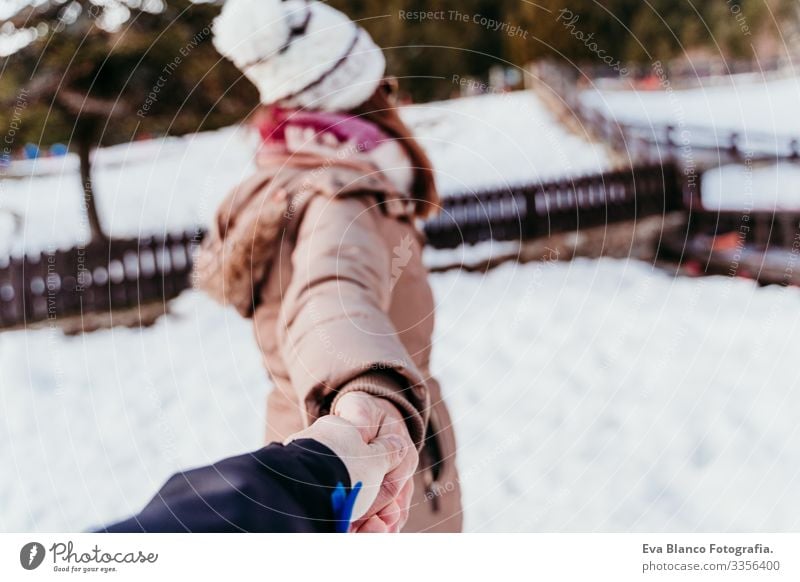 Folgen Sie mir. Frau und Mann halten sich an den Händen. pov. Wintersaison am Berg. Konzept der Liebe Hand mir folgen Schnee Freund Freundin Halt Valentinstag