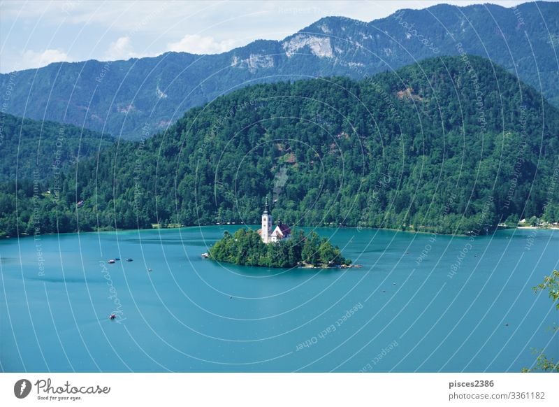 Traditional Pletna boats around Bled island on lake Bled Ferien & Urlaub & Reisen Sommer Strand Tower (Luftfahrt) dumm Religion & Glaube sky green water tourism