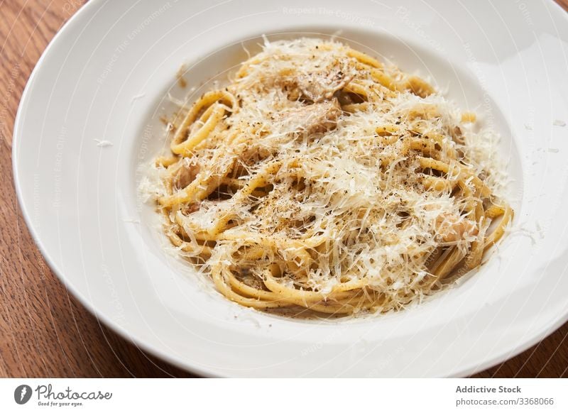 Portion Nudeln mit Parmesan Spätzle Spaghetti traditionell kulinarisch Käse Speise Lebensmittel Teller Restaurant Mahlzeit hölzern Tisch klassisch Italienisch