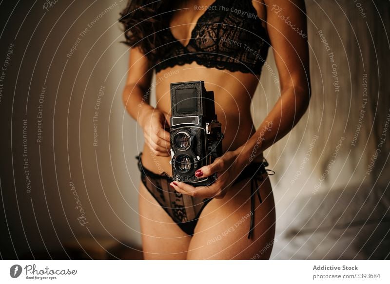 Gesichtslose Dame in Dessous mit Fotokamera Frau Unterwäsche altehrwürdig Fotoapparat Schlafzimmer erotisch Hobby verführerisch schlank BH sinnlich sexy retro