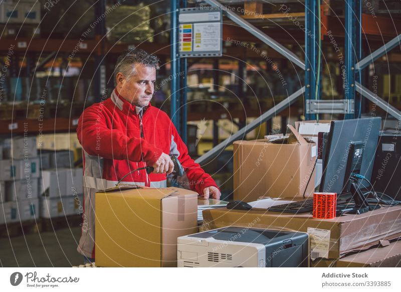 Mann scannt Pakete bei der Arbeit im Lager Lagerhalle logistisch Dienst männlich Kasten Job Versand Industrie professionell Kauf modern Orden Kollo Beruf