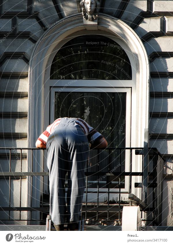 Hoch oben auf der Leiter tief über das Balkongeländer gebeugt verfluchte er leise die verlorene Kontaktlinse.. Handwerker arbeiten Arbeit & Erwerbstätigkeit