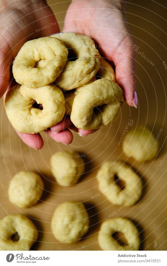 Nutzpflanzenweibchen machen Donuts aus Teig Frau Krapfen Koch Teigwaren Tisch Ring Form heimwärts Gebäck Lebensmittel frisch Snack Bäckerei Dessert süß Mahlzeit