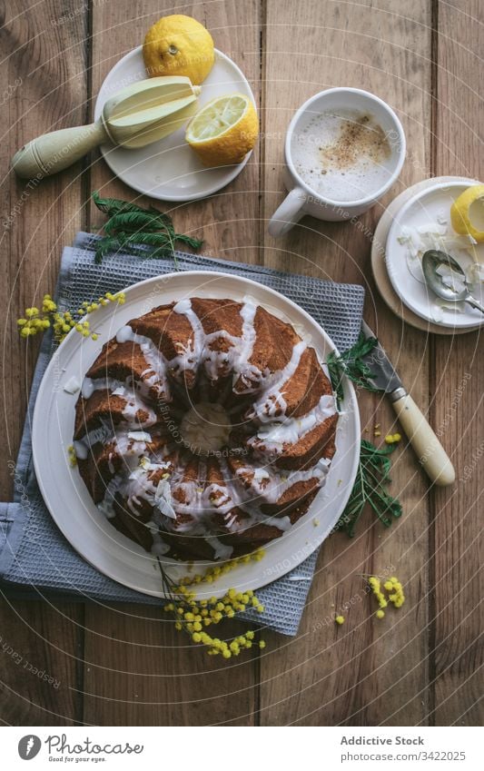 Stilvoll servierter Zitronen-Kokos-Kuchen Dessert Kokosnuss Tisch Teller hölzern Bestandteil dienen dekorieren Veganer Lebensmittel lecker geschmackvoll süß