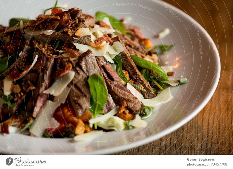 Beefsteak-Salat mit Salat, Rucola und Spinat mit Parmesan und
hausgemachte würzige Croutons Salatbeilage Teller Gemüse Restaurant Mahlzeit Rindfleisch gegrillt