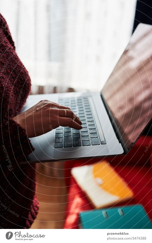 Mutter einer Frau, die während der COVID-19-Quarantäne während eines Video-Chat-Call-Stream-Online-Kurses auf einem Laptop von zu Hause aus ihren Job aus der Ferne erledigt. Frau sitzt im Bett vor dem Computer und schaut auf den Bildschirm