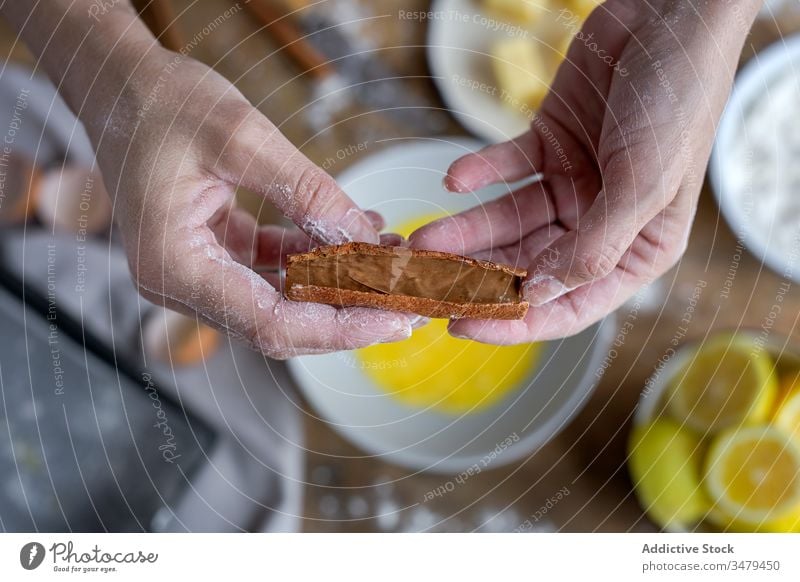 Gesichtslose Frau mit Zimtstangen Stöcke Wittern Bestandteil Aroma frisch Hände trocknen Lebensmittel Ernährung Essen zubereiten Zitrone von oben Mehl Bäckerei