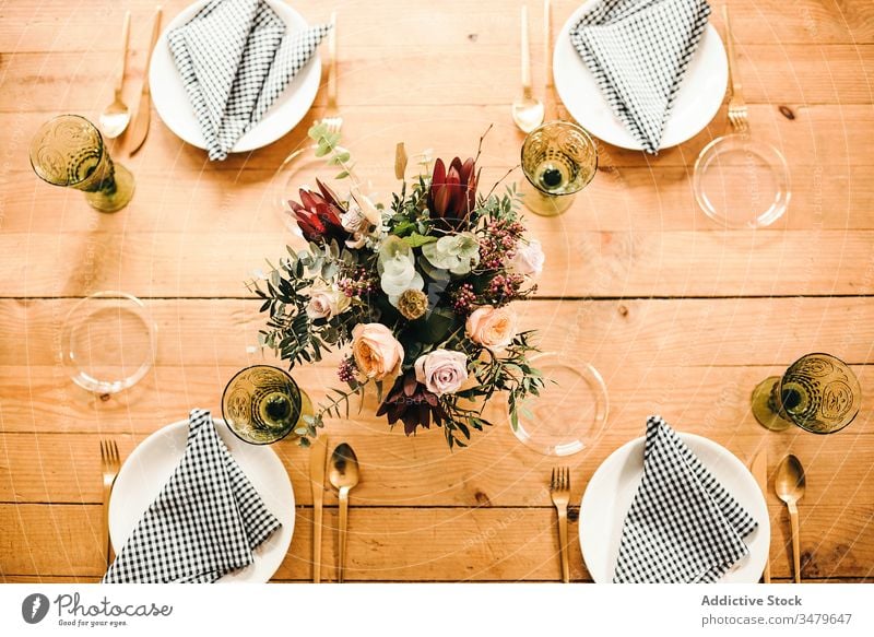 Blumen und Pflanzenzweige auf einer Vase, die einen Holztisch schmückt Haufen Blatt Blumenstrauß Wasser Blütenblatt Konzept Glas frisch Blütezeit Innenbereich