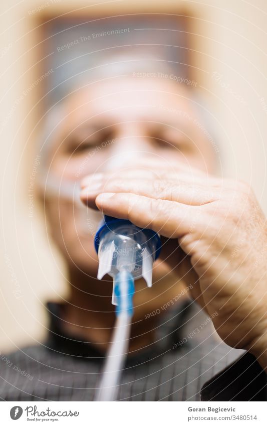 Älterer Mann mit medizinischer Ausrüstung zur Inhalation mit Atemmaske, Vernebler Aerosol Air Allergie Asthma Asthmatiker Atmung bronchiale Bronchitis Pflege