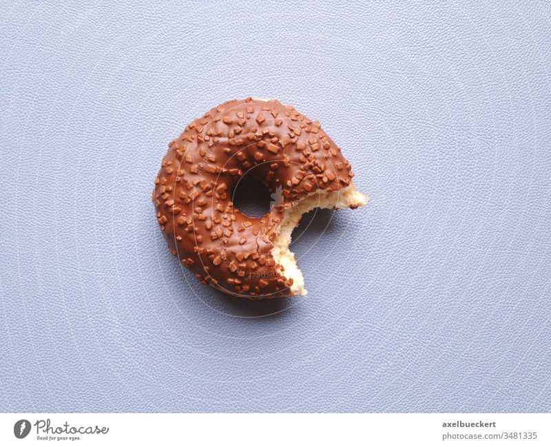 angebissener Schoko Donut oder Doughnut Schokodonut schoko halb aufgegessen Gebäck süß Lebensmittel Snack Dessert ungesund Essen Frühstück Kalorien Zucker Biss