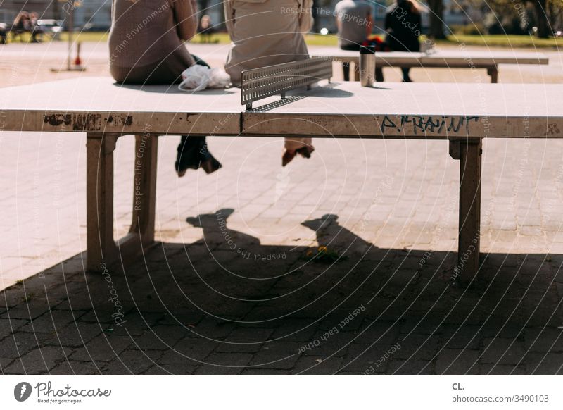 menschen sitzen auf tischtennisplatten Tischtennisplatte Pause Pause machen Spielplatz Mittagspause Park Menschen personen Erholung Außenaufnahme Tag Farbfoto