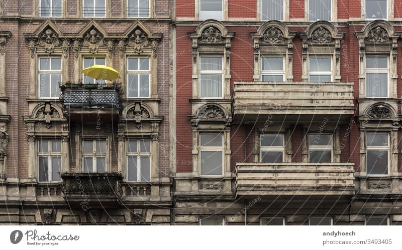 Der gelbe Sonnenschirm auf dem Balkon des alten Hauses antik Antiquität Appartement Bogen Architektur Balkone Berlin Backsteinwand Gebäude Gebäudeaußenseite