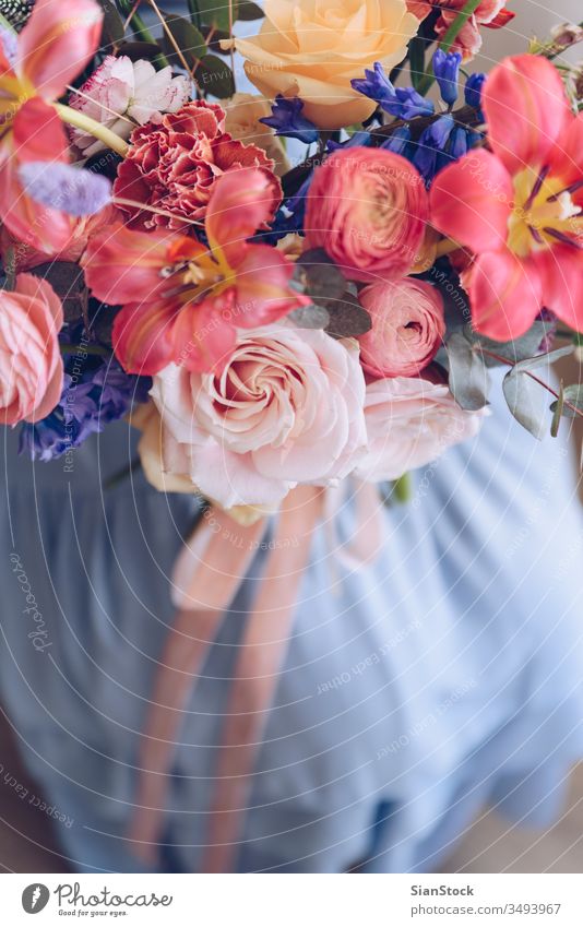 Junge Frau in einem hellblauen Kleid mit einem Blumenstrauß in der Hand. Romantisches Konzept. Mädchen weiches Licht schön altehrwürdig Hochzeit weiß jung