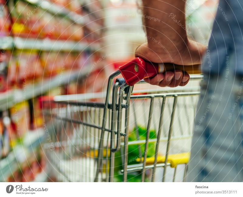 Einkaufswagen im Gang des Supermarkts, Kopierraum Handwagen Lebensmittelgeschäft Werkstatt Karre Mann Hände Latein Kaukasier Halt Laden Markt Einzelhandel Regal