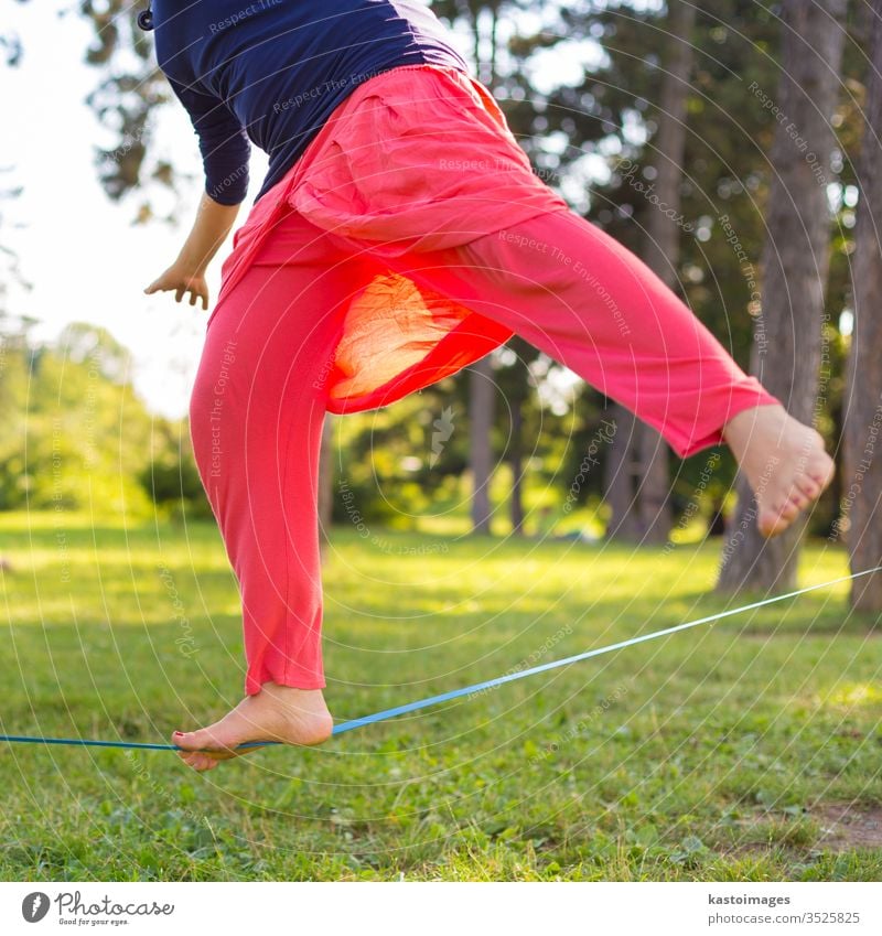 Slackline im Stadtpark. Schlaffleitung Aktivität Sport Gleichgewicht schlaff Linie Drahtseil jung Person Seil Fitness Rücken Natur Konzentration passen laufen