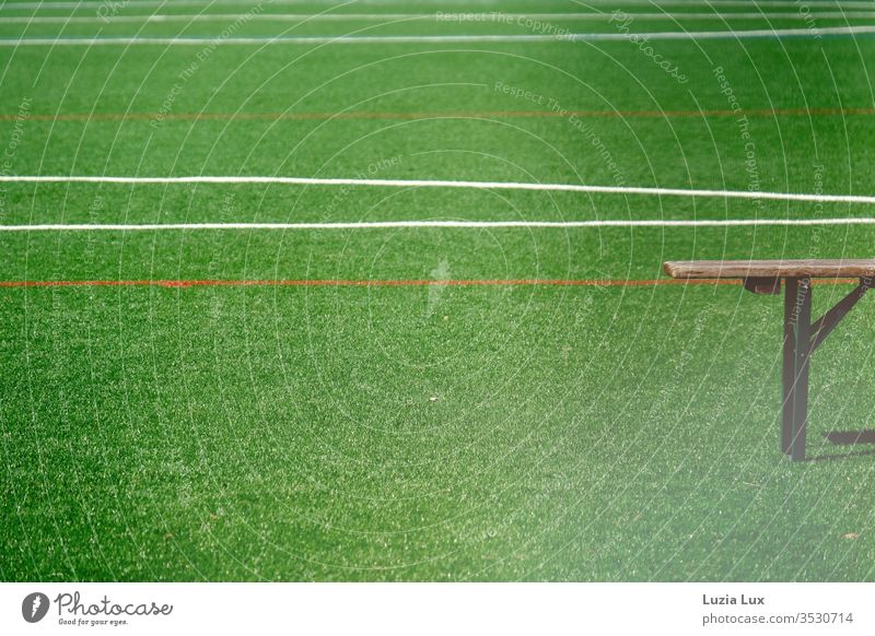 Leere Bank auf einem leeren Sportplatz, mit viel Sonnenschein Bierbank Rasen Rasenplatz Linien grün Fußball Spielen Fußballplatz Ballsport Außenaufnahme