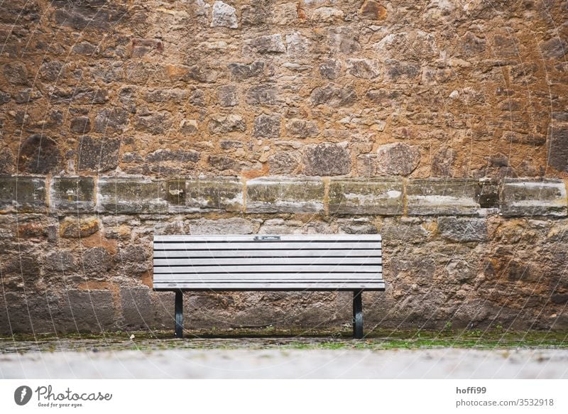 die Bank steht leer und wartet auf Besucher Sitzban Burgmau Sandsteinmauer Standstein Fassade Mauer Wand Altstadt Altstadthaus Burg oder Schloss Bughof alt