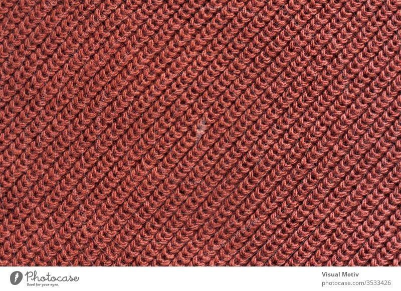 Textur eines Gestricks aus roter Wolle Textil texturiert Mode Gewebe Hintergrund Oberfläche Design abstrakt Nahaufnahme niemand Detailaufnahme Strickwaren