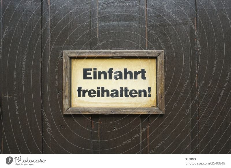 Schild "Einfahrt freihalten!" mit Holzrahmen an einem dunklen Holztor Ausfahrt Gebot Tor Schilder & Markierungen Rücksichtnahme Mitteilung Kommunikation