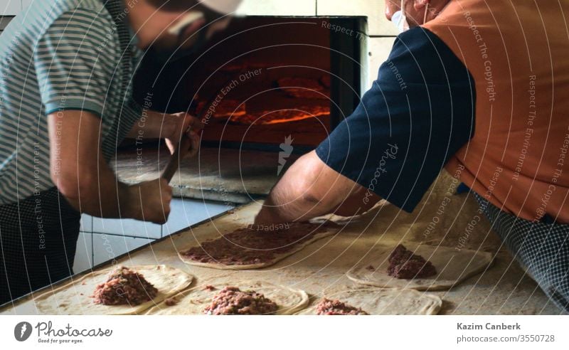 Zwei männliche Bäcker bereiten im Ramadan traditionelle türkische Pita zu und erhitzen sie Bäckerei Koch Lebensmittel Mahlzeit lecker geschmackvoll Truthahn