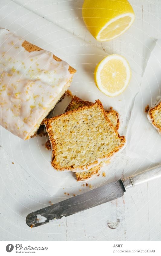 Draufsicht auf Scheiben eines glasierten Zitronen-Pfundkuchens mit Mohn Kuchen Brotlaib Pfannkuchen Zitronenbrot verglast Samen Zitronenschale flache Verlegung