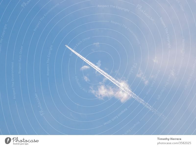 Ein Flugzeug, das einen Kondensstreifen oder Kondensstreifen hinterlässt. Himmel Blauer Himmel reisen Luftweg Wolken fliegen Urlaub Reise-Freizeit Freiheit