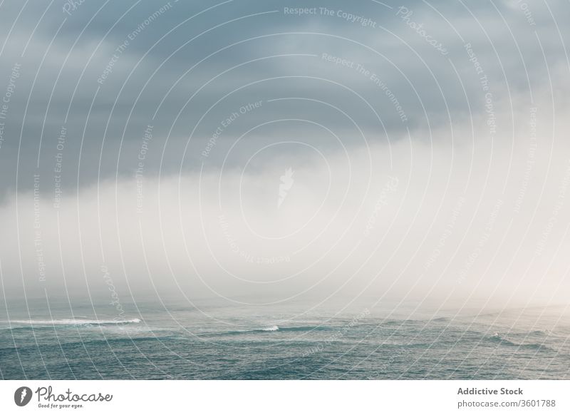 Ruhiges Meer nahe des Hügels unter bewölktem Himmel bei nebligem Wetter MEER Nebel Meereslandschaft Cloud atemberaubend malerisch Natur spektakulär Spanien