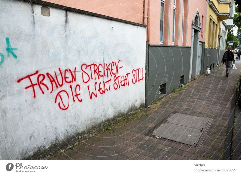 Wenn die Frauen streiken steht die Welt still. Frauenbewegung für Gleichstellung der Frau in Beruf und Bezahlung.Angemessene  Würdigung für die Leistung der Frau in der Gesellschaft. Grafitti auf einer Mauer