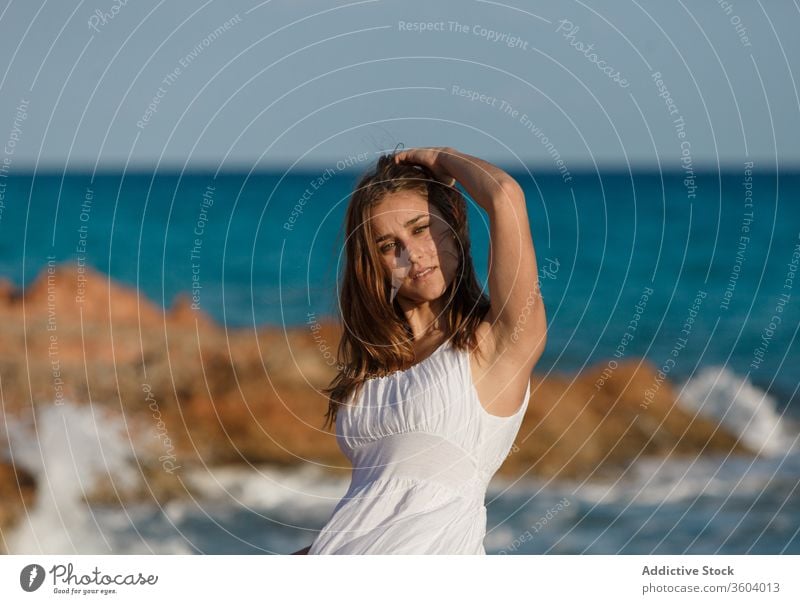 Zärtliche Frau in weißem Kleid am Meeresufer im Sommer MEER Urlaub Angebot Strand Meereslandschaft Feiertag genießen Gelassenheit türkis Wasser sonnig Wetter