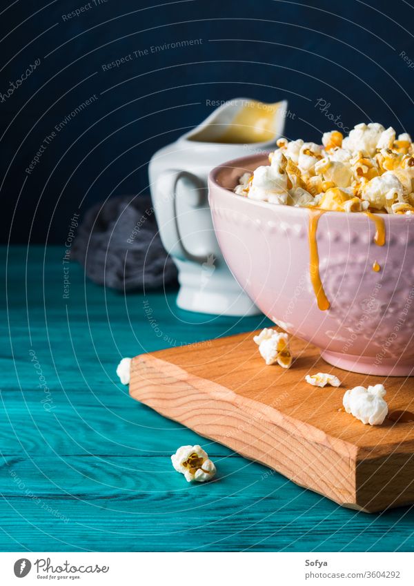 Popcorn mit Karamell in Schale auf dunklem Hintergrund Popkorn Mais Schalen & Schüsseln Saucen süß gekocht Lebensmittel Snack knackig salzig lecker Atelier