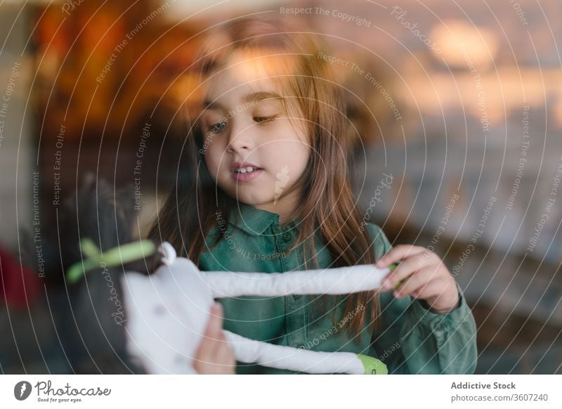 Süßes Mädchen mit Plüschtier zu Hause bezaubernd Kind Spielzeug Puppe charmant gemütlich heimwärts Kindheit niedlich sich[Akk] entspannen unschuldig sitzen