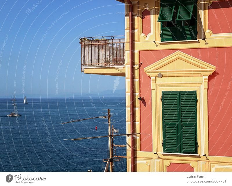 Genua, - Blick vom Felskap, das die Bucht von Boccadasse abschließt, auf den blauen Golf des Tigullio und das Profil eines charakteristischen ligurisch bemalten Hauses