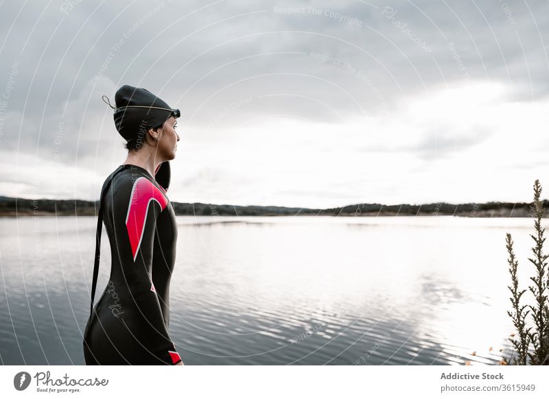 Frau im Taucheranzug mit Brille am Seeufer Neoprenanzug Schutzbrille Badeanzug Ufer extrem Umwelt Schwimmer aqua sportlich reisen Bestimmen Sie schwimmen