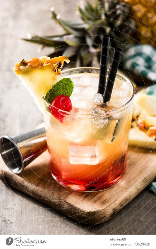 Kalter Mai-Tai-Cocktail mit Ananas und Kirsche auf Holztisch alkoholisch Getränk Schnaps kalt lecker trinken Lebensmittel frisch Frucht Glas Saft Kalk mai tai