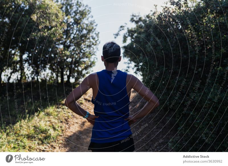 Entschlossener Mann, der während des Trainings auf der Natur steht Stehen laufen schnell Übung Fitness jung Sport passen Aktivität Sportbekleidung joggen urban