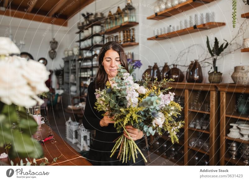 Weibliche Designerin entwirft Blumensträuße im Atelier Floristik Frau Blumenstrauß einrichten kreieren Blütezeit komponieren dekorativ kreativ Arbeit Beruf